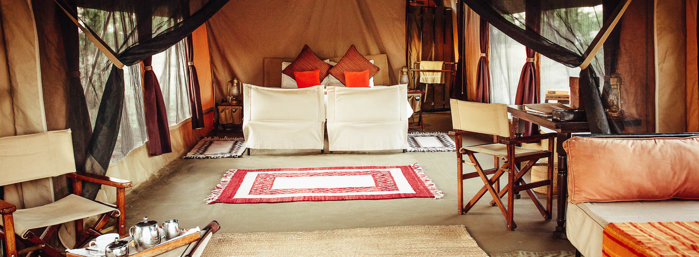 serengeti safari camps Great Wildebeest Migration olakira camp interior tented suite private lounge wooden furniture