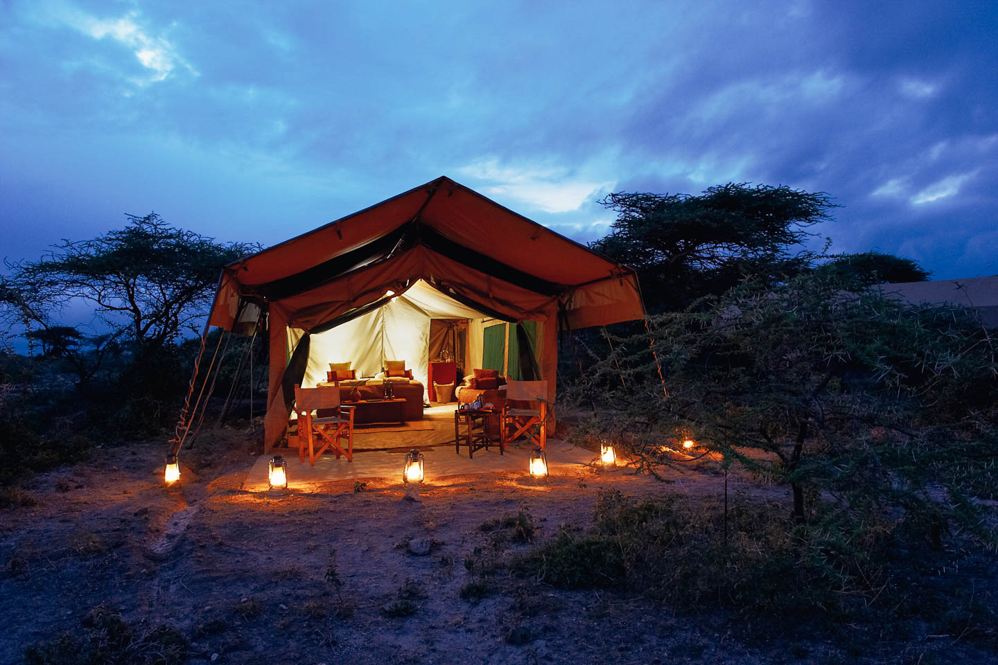 serengeti safari camps Great Wildebeest Migration ubuntu camp exterior tented suite twilight lanterns