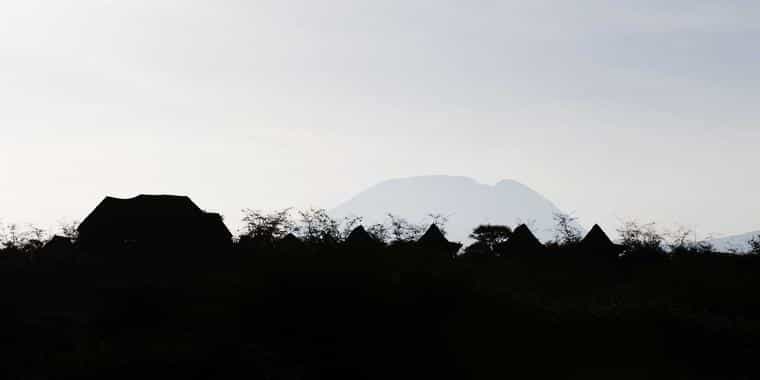 Silouette of the camp and Kilimanjaro behind