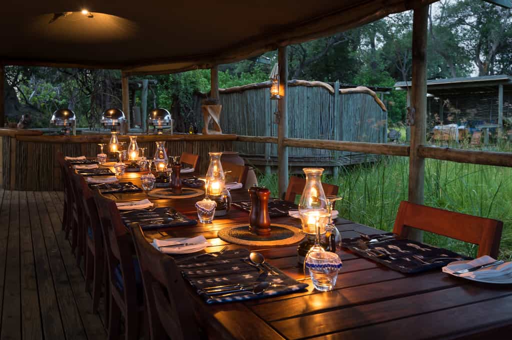 Dining area with swimming pool discreetly in the background