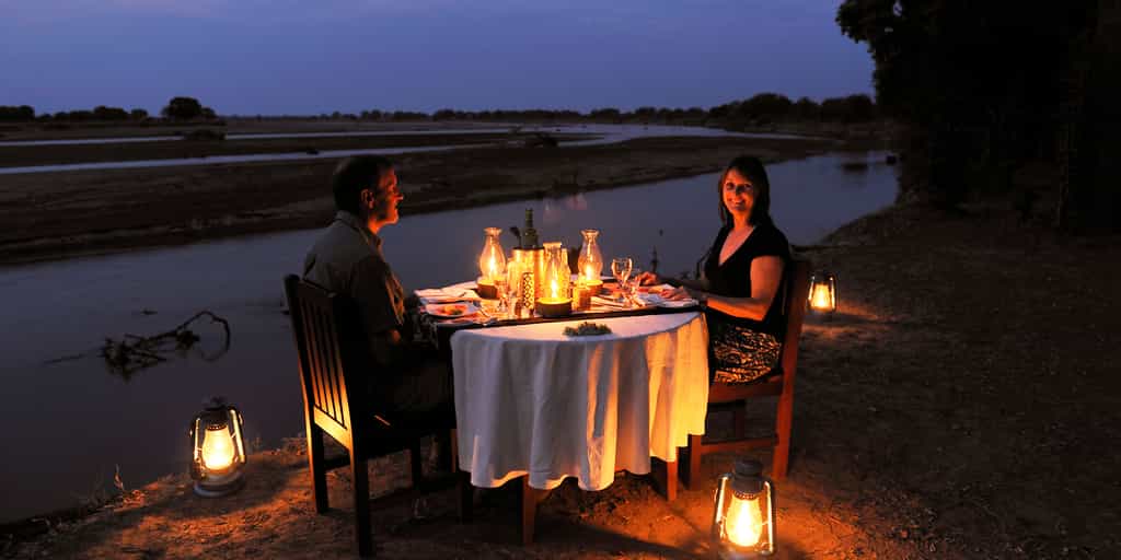 Romantic riverside dinner setting