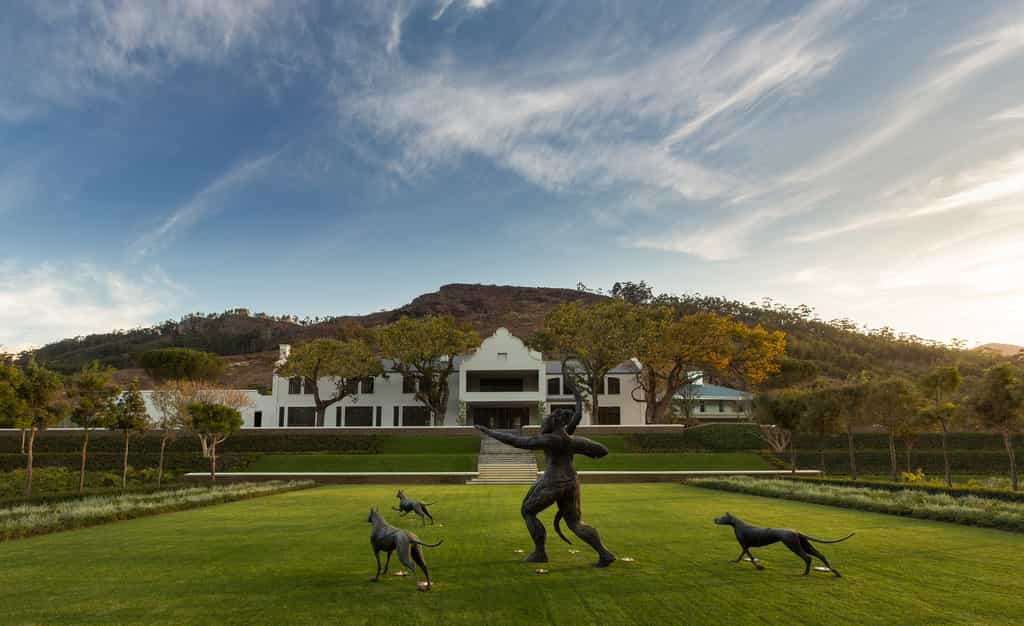 Manor House at Leeu Estate with Artemis and her three dogs in the foreground