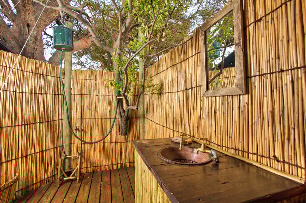 Oper air bathroom with bucket showers