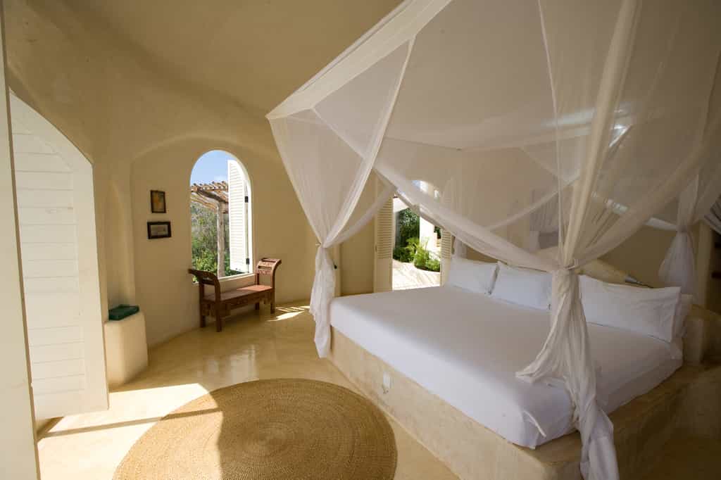 Open to the ocean breeze, a luxurious pavilion bedroom.