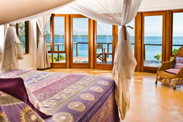 Each villa has a spacious bedroom which extends onto a balcony with a view.