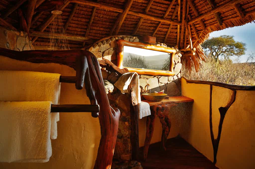 Bathroom designed with all-natural materials and affording views over the Loisaba landscape