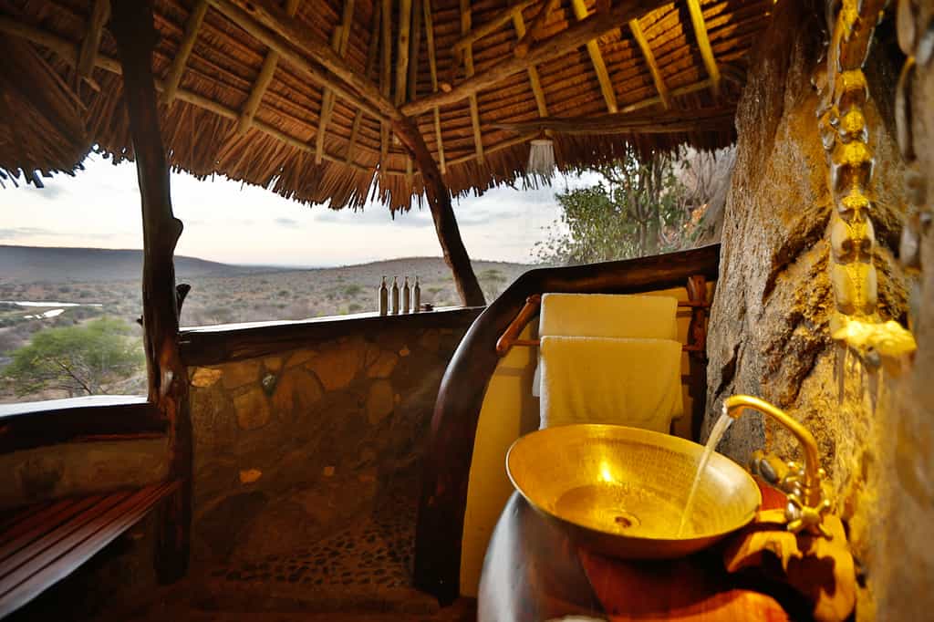 Bathroom designed with all-natural materials and affording views over the Loisaba landscape