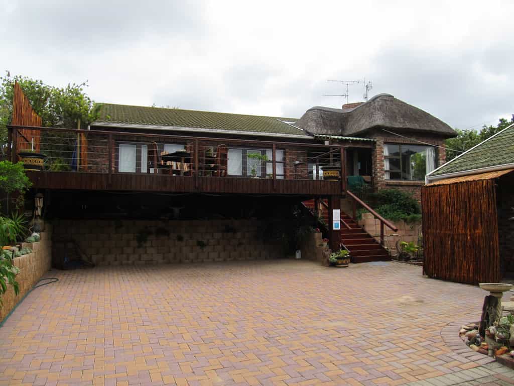 Entrance and driveway towards guest house with safe parking behind electronic gates. Lapa attached with indoor braai/fireplace and big open deck with view of river and dunes across the road.