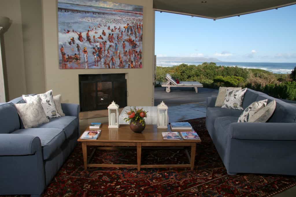 Our main lounge with a huge fireplace and beautiful view of the natural Fynbos Garden 