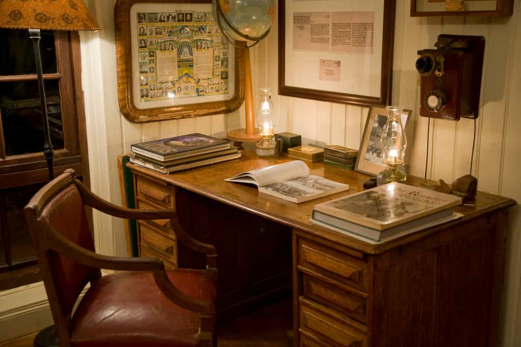 Antique library desk in the lounge dotted with memorabilia