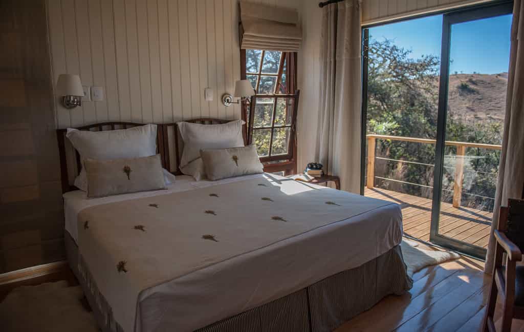Churchills Bedrooms with open glass doors leading onto deck overlooking Spioenkop Game Reserve