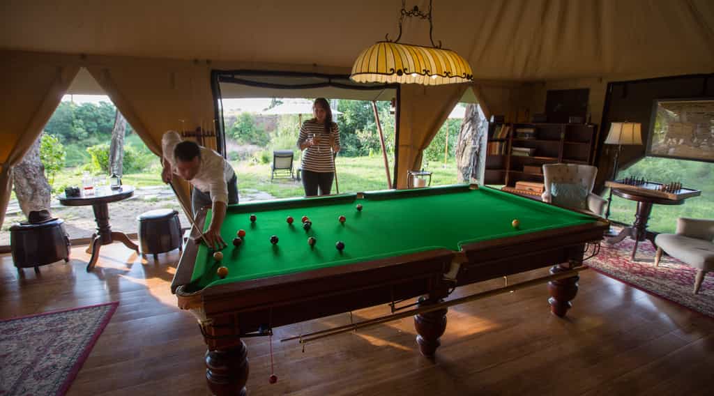 A game of pool against the backdrop of the Masai Mara
