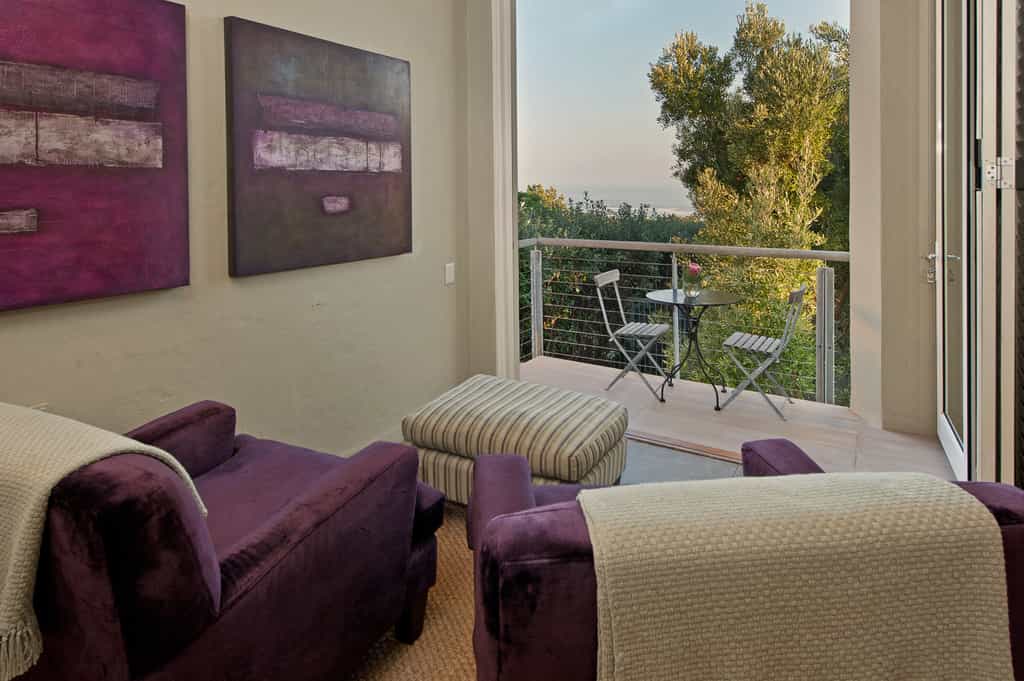Seating area leading onto a sea facing balcony with sea view