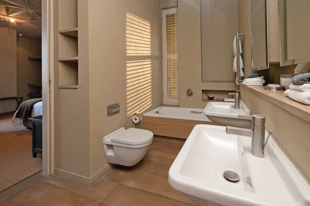 Bathroom with bath, shower, toilet and double twin basins
