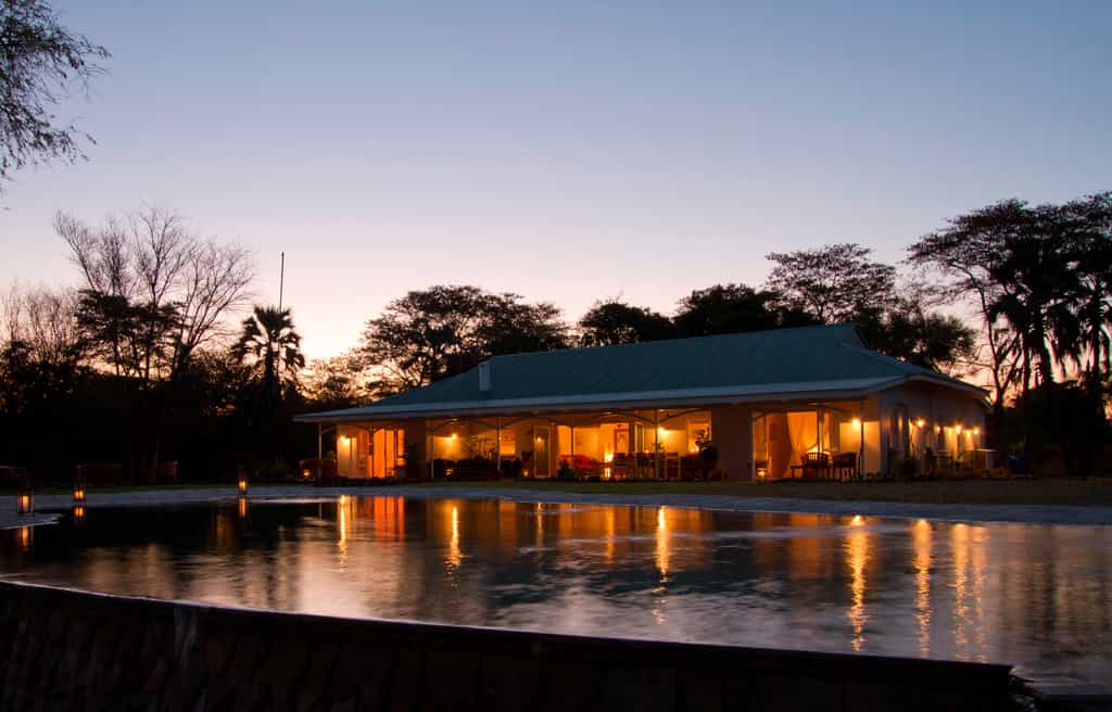 Huge windows and patio doors look out across the pool and the river, with the verandah perfect for out sundowners and eating alfresco