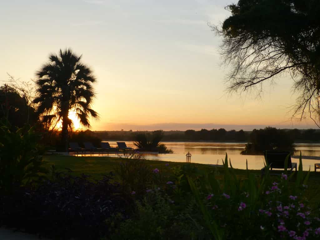 Sunrise from The River Farmhouse looking out over the infinity pool and Zambezi River