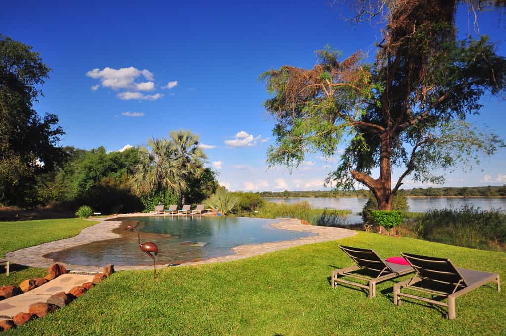 Vast open lawns surround the infinity swimming pool