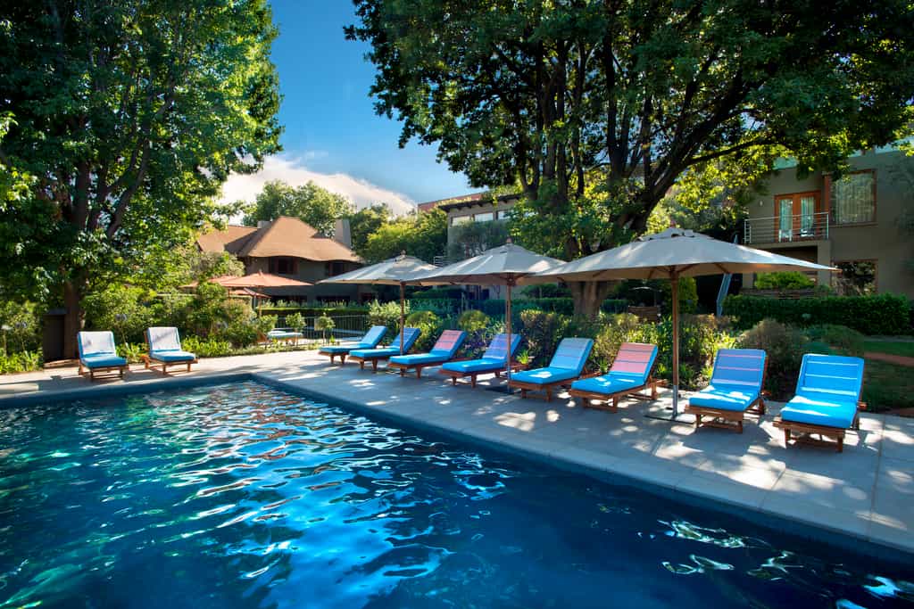 Larger lap pool with sun loungers and umbrellas