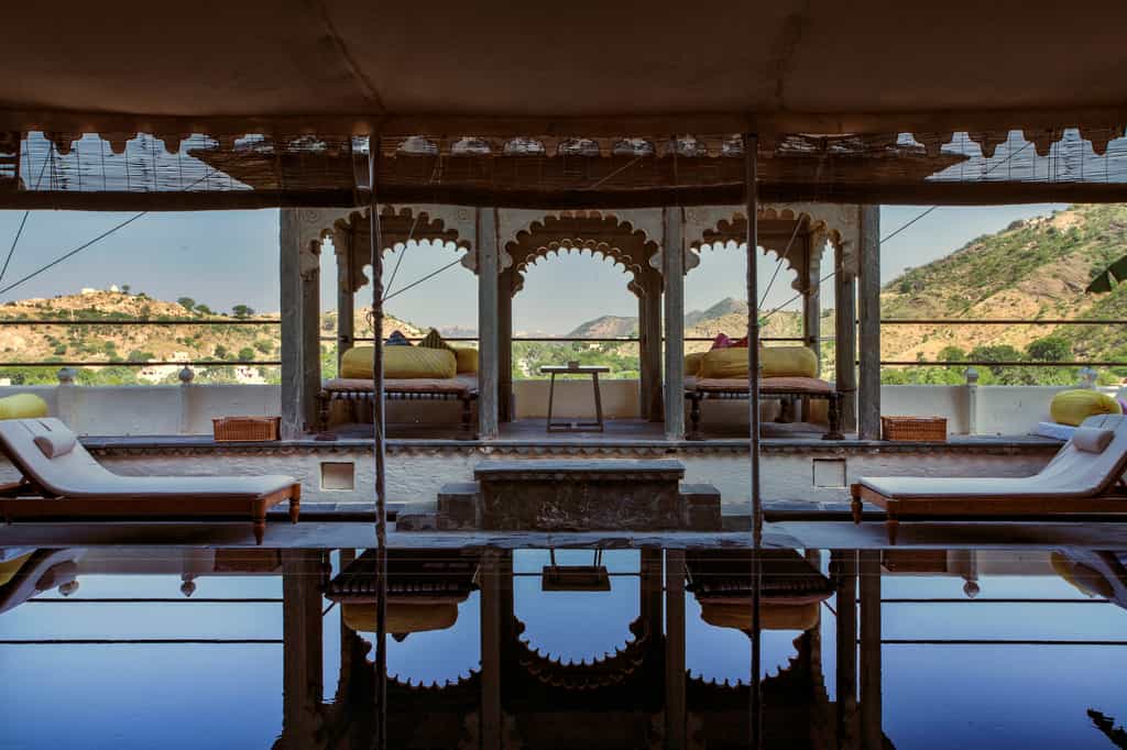 Private pool with lounge and deck seating in Devigarh Suite
