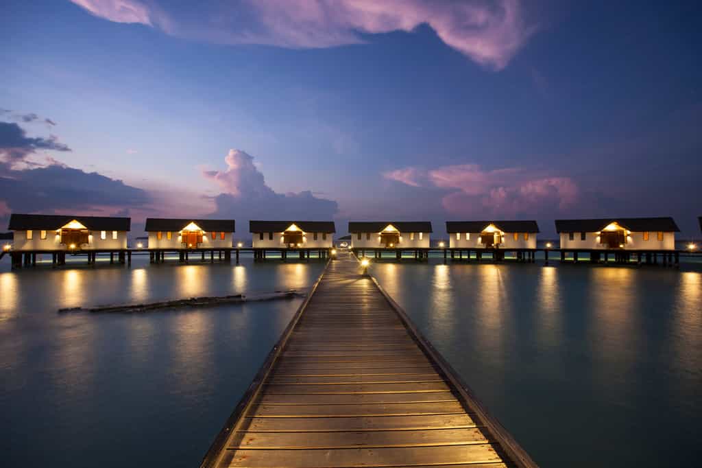 View of water villas during sunset