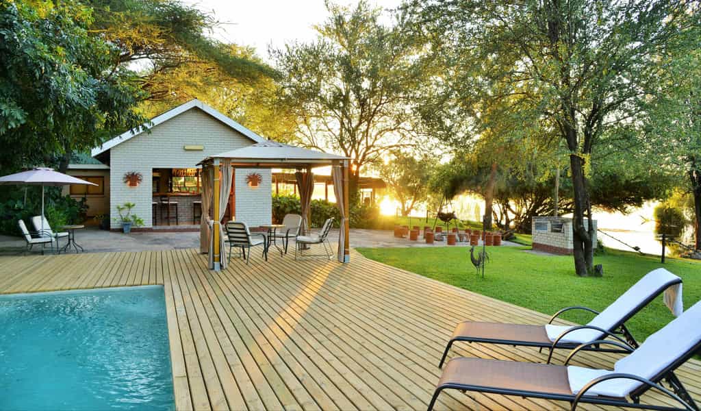 Public area at River View Lodge, including swimming pool and bar overlooking the Chobe River.