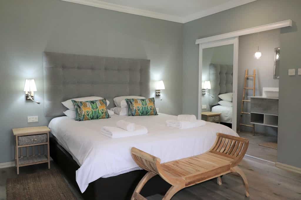 Spacious Deluxe Double Chalet featuring king-size bed, en-suite bathroom, air-conditioning, refreshment station, private veranda and private deck with views of the Chobe River.