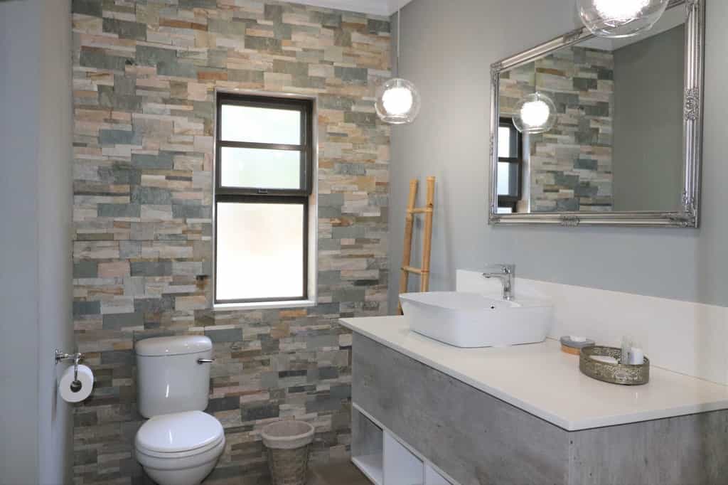 Spacious Deluxe Double Chalet featuring king-size bed, en-suite bathroom, air-conditioning, refreshment station, private veranda and private deck with views of the Chobe River.