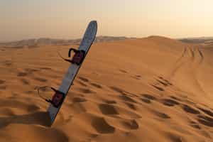 Sand board down the desert dunes of Siwa Oasis