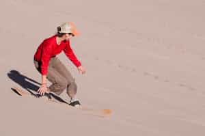 Sandboard down the dunes of the Atacama Desert