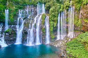 Swim underneath a waterfall in Reunion Island