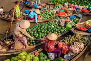 Join the bustle of a floating market in the Mekong