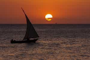 Sail out at sunset on a traditional dhow in Lamu