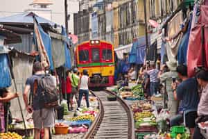 Explore the Maeklong Railway market in Bangkok