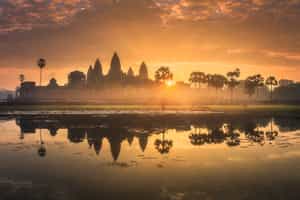 See the sunrise over the temples of Angkor Wat