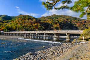 Walk across the ancient Togetsukyo Bridge, Kyoto