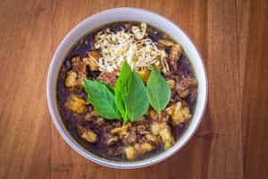 Try Indonesian black beef soup in Malang