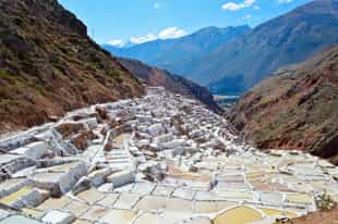 Look over the surreal view of the Maras salt mines
