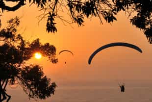 Paraglide over the rooftops and waves of Lima