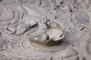 Take a mud bath and swim at the hot springs