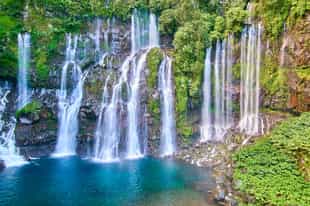 Swim underneath a waterfall in Reunion Island