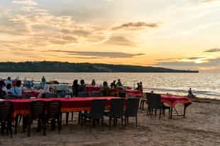 Enjoy a sunset dinner at Jimbaran Bay