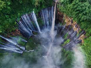 Visit the cascading curtain waterfall of Tumak Sewu
