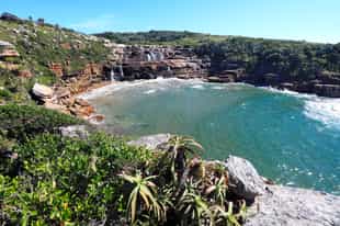 Discover cascading falls that meet the sea at GweGwe