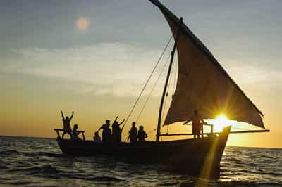 Sail a dhow at sunset