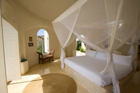 Open to the ocean breeze, a luxurious pavilion bedroom.