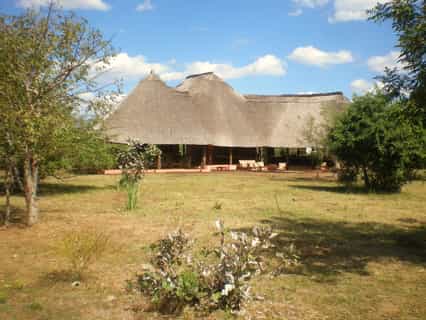 You'll find the lounge, the bar, reception and dinner area there. The pool is 50 meters from the main building, 4 chalets on the right and 5 on the left hand side.