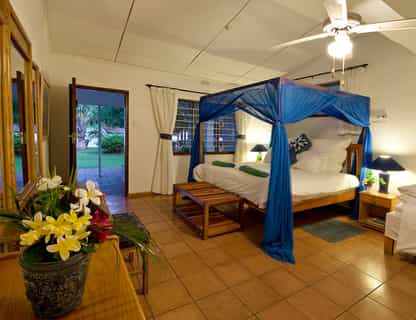 Canopy mosquito nets over beds.  Rooms decorated in cool blues to a nautical theme. 