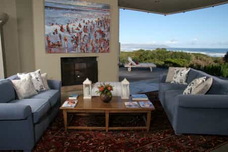 Our main lounge with a huge fireplace and beautiful view of the natural Fynbos Garden 
