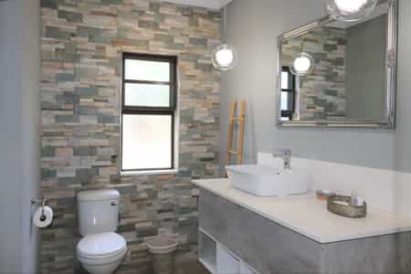 Spacious Deluxe Double Chalet featuring king-size bed, en-suite bathroom, air-conditioning, refreshment station, private veranda and private deck with views of the Chobe River.